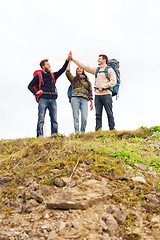 Image showing group of smiling friends with backpacks hiking