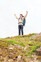 Image showing smiling man with backpack hiking