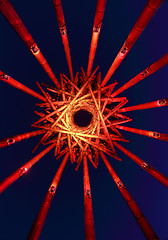 Image showing Abstract view of Save Our Souls sculpture lit up red