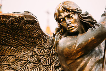 Image showing Statue Of Archangel Michael With Outstretched Wings Before Red C