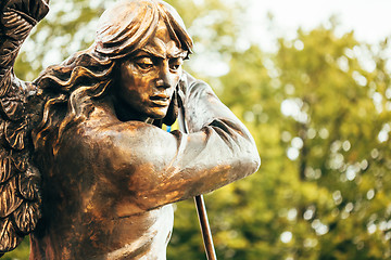 Image showing Statue Of Archangel Michael With Outstretched Wings Before Red C