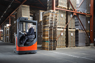 Image showing Reach truck driver in a warehouse