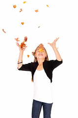 Image showing Girl with falling leaves.