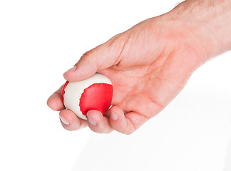 Image showing Male hand with a red and white ball