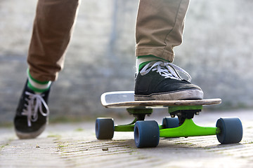 Image showing Skateboarder departing 