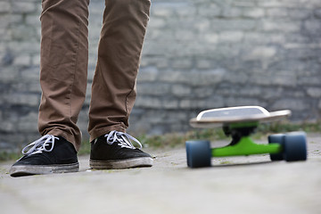 Image showing Skateboarder feet and skateboard in urban setting