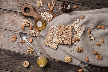 Image showing Cookies with seeds, nuts, honey on wooden table