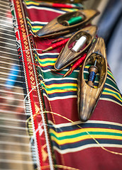 Image showing Wooden Weaving shuttles and textured textile