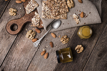 Image showing Cookies with seeds  honey  and nuts on wooden table