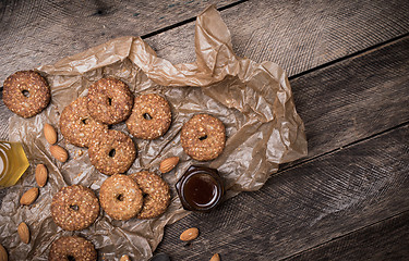 Image showing Nuts and Cookies on paper and wooden table