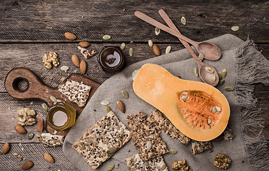 Image showing Pumpkin nuts  honey and seeds on wooden table