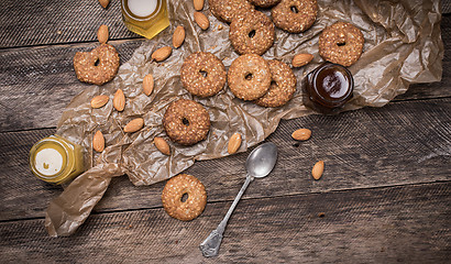 Image showing Nuts and Cookies with sesame on wooden table