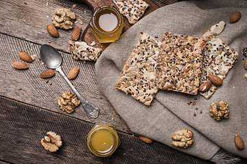 Image showing Cookies with seeds,  honey on napkin and wooden table