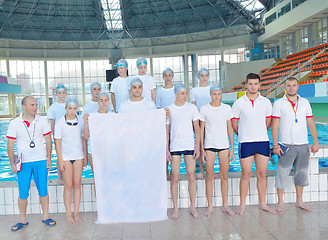 Image showing children group  at swimming pool with empty white flag