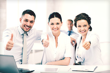 Image showing business team showing thumbs up in office