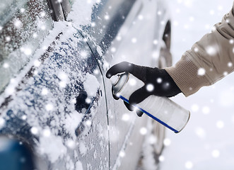 Image showing closeup of man hand with lock door de-icer