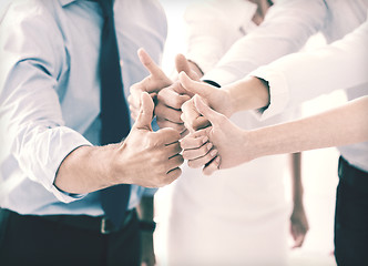 Image showing business team showing thumbs up in office