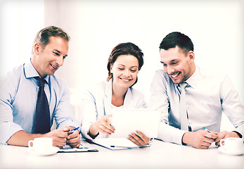 Image showing business team looking at tablet pc in office