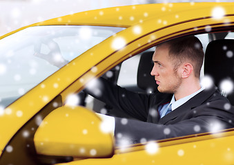 Image showing close up of businessman driving car