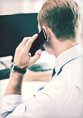 Image showing businessman with smartphone in office