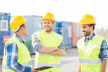 Image showing smiling builders in hardhats with tablet pc