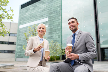 Image showing smiling businessmen with paper cups outdoors