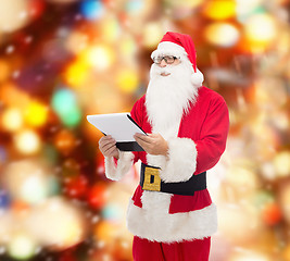 Image showing man in costume of santa claus with notepad