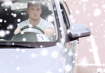 Image showing man driving car and putting parking clock