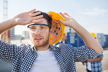 Image showing group of builders in hardhats outdoors