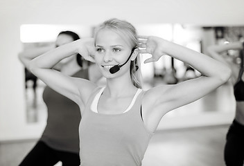 Image showing group of smiling people exercising in the gym