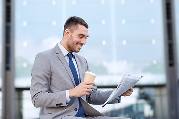 Image showing young businessman with coffee and newspaper