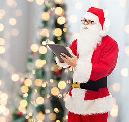 Image showing man in costume of santa claus with tablet pc