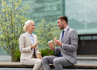 Image showing smiling businessmen with paper cups outdoors