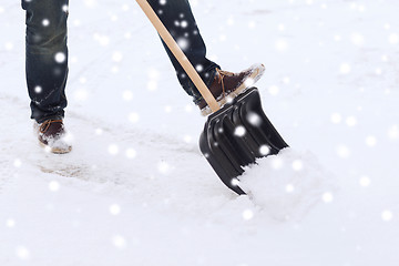 Image showing closeup of man digging snow with shovel