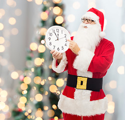 Image showing man in costume of santa claus with clock