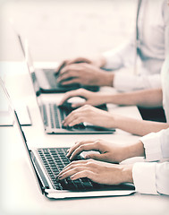 Image showing group of people working with laptops in office