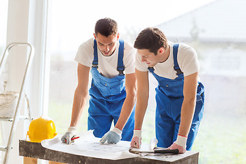 Image showing group of builders with blueprint