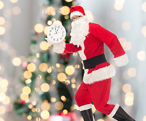 Image showing man in costume of santa claus with clock