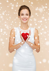 Image showing smiling woman in white dress with red heart