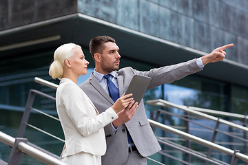 Image showing serious businessmen with tablet pc outdoors