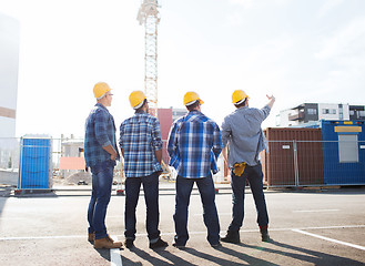 Image showing group of builders in hardhats outdoors