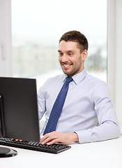 Image showing smiling businessman or student with computer