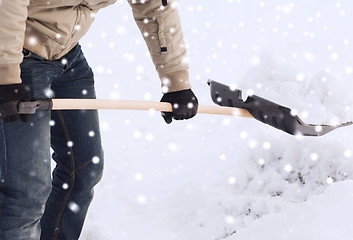 Image showing closeup of man digging snow with shovel