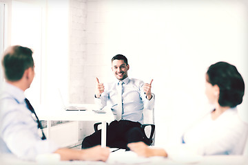 Image showing businessman showing thumbs up in office