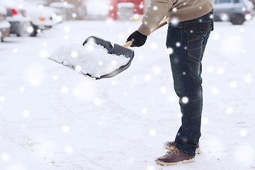 Image showing closeup of man digging snow with shovel near car