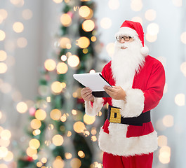 Image showing man in costume of santa claus with notepad