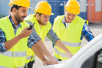 Image showing group of smiling builders in hardhats outdoors