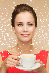 Image showing smiling woman in red dress with cup of coffee