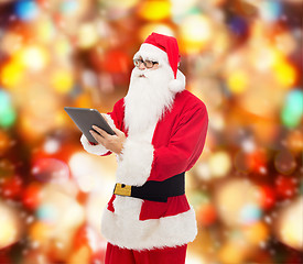 Image showing man in costume of santa claus with tablet pc