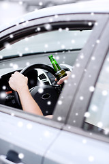 Image showing close up of man drinking alcohol while driving car